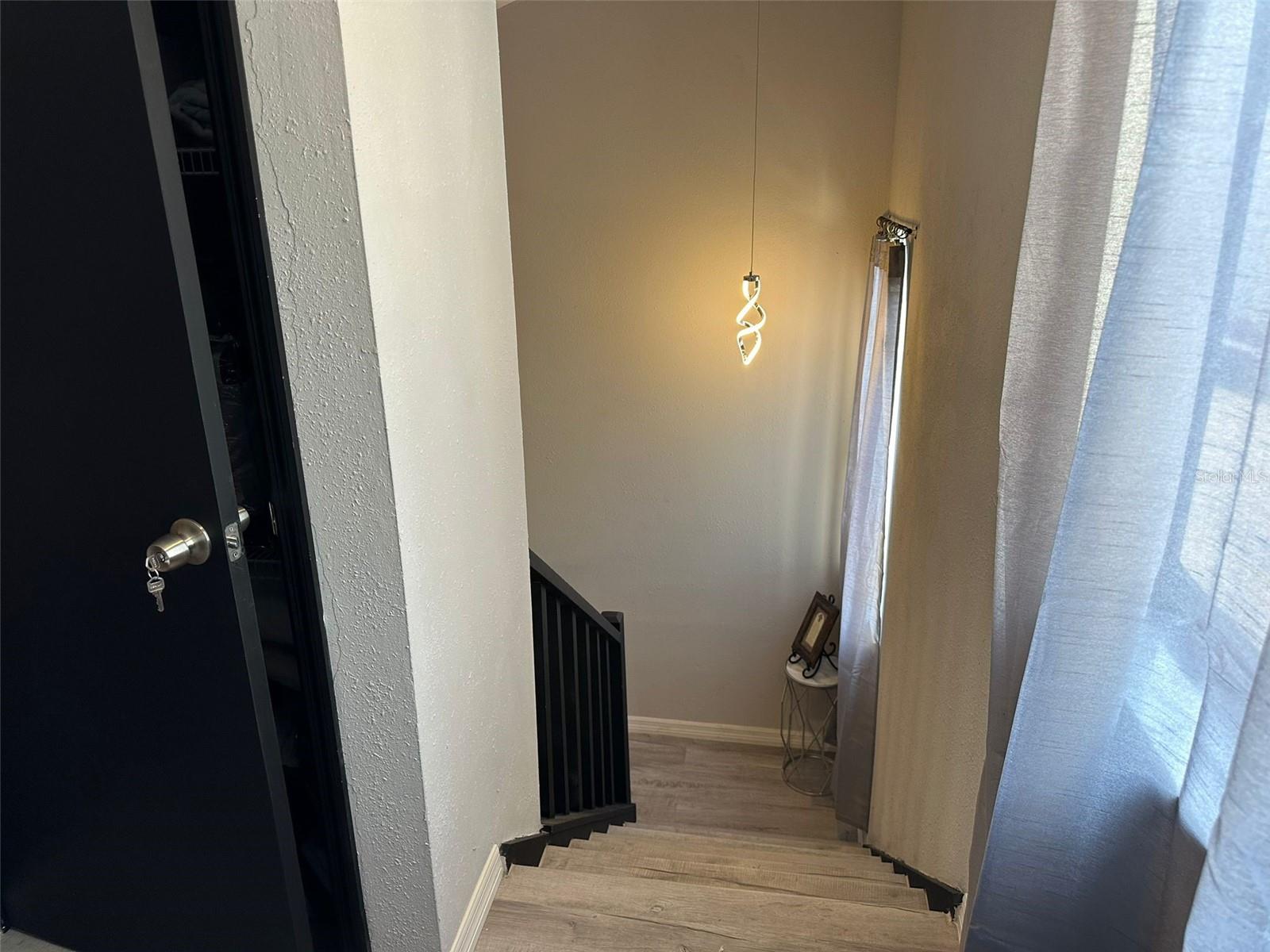 Look from the second room upstairs towards the stairs - Door to the left is a linen closet