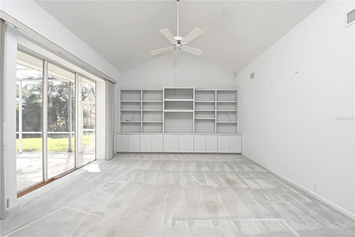 The family room, with its built-in bookshelves, offers a unique opportunity – imagine adding windows along the back wall to frame the spectacular water and conservation view.