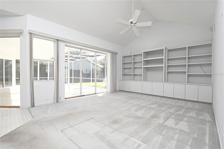 The family room has sliding glass doors to the screened in lanai.