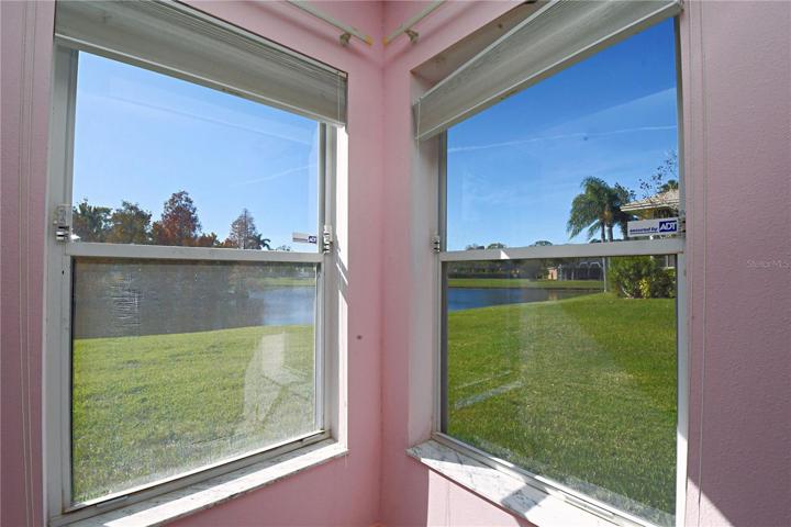 Bedroom 4 has corner windows with a beautiful view of the pond and conservation.