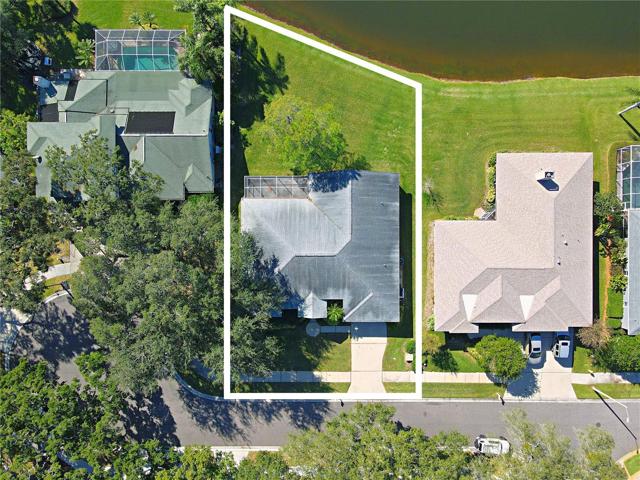 Step into the backyard, where 86 feet of water frontage on a spring-fed pond, stocked with bass, offers a serene retreat.