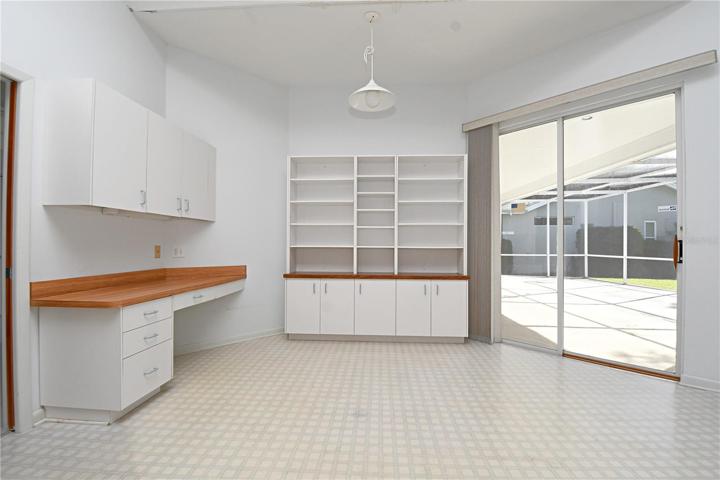 The kitchen has a built in desk and cabinet.
