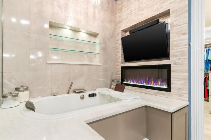 Soak in your jacuzzi tub with fireplace and TV