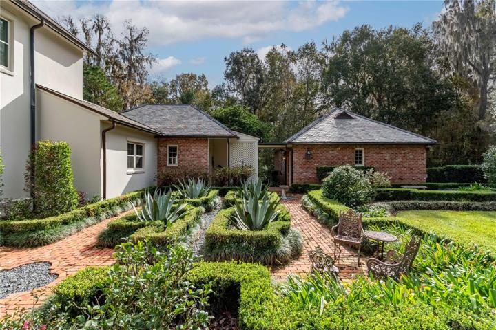 Side garden with view of garage.