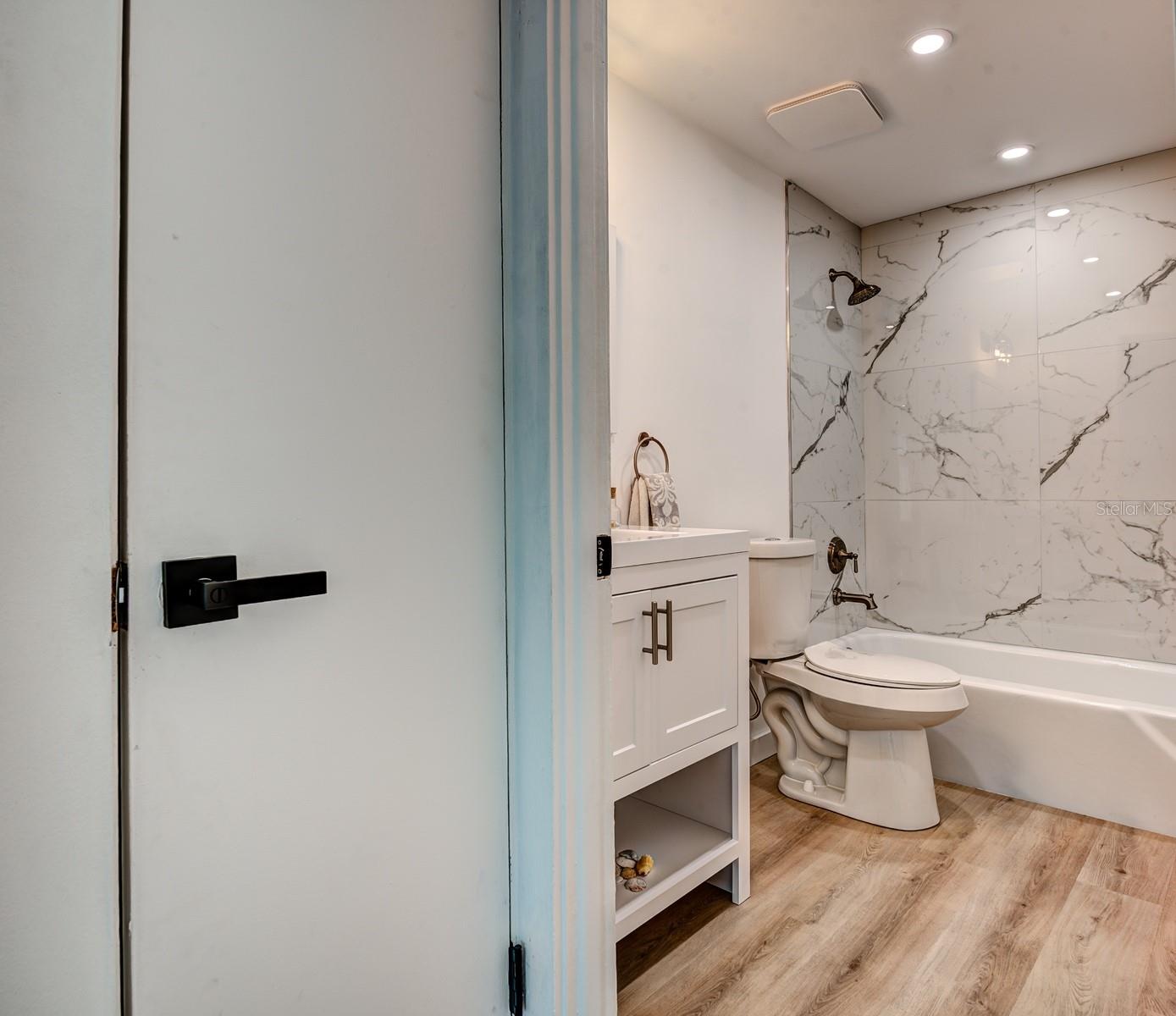 The second bath features a tub/shower combination, porcelain tiled shower walls, shampoo niche, new designer vanity, lighting, plumbing fixtures and comfort height commode.