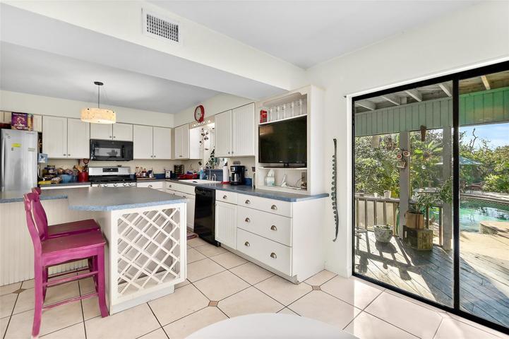 Kitchen with sliders to covered patio.
