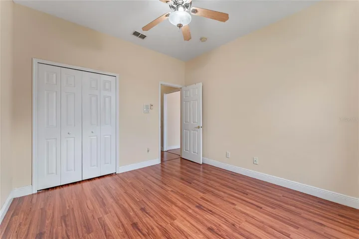 MIL bedroom 1st floor - view 2 leading to hallway private BA.  Hallway pocket door, off family room