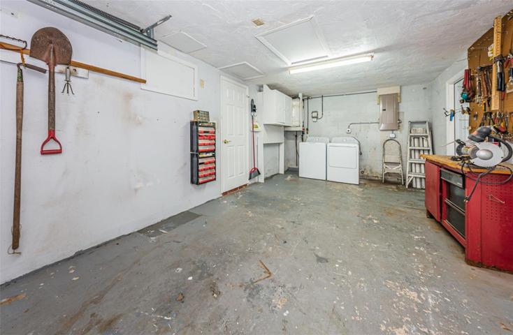 Garage with full size washer/dryer .  Also brand new 220/150 amps electrical panel box . New service door out to side yard.