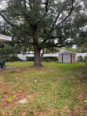 Huge Backyard with storage shed contains lawn mower and lots of yard equipment