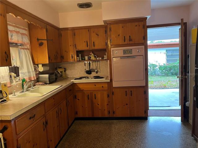 Kitchen with Entry Door from Carport and Laundry access