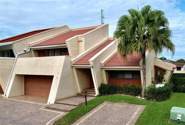 Front of townhome, with designated parking, in addition to two car garage