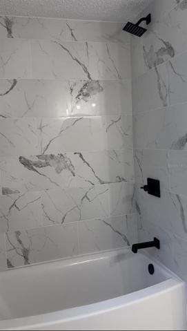Secondary bathroom with high=end bathtub and fixtures