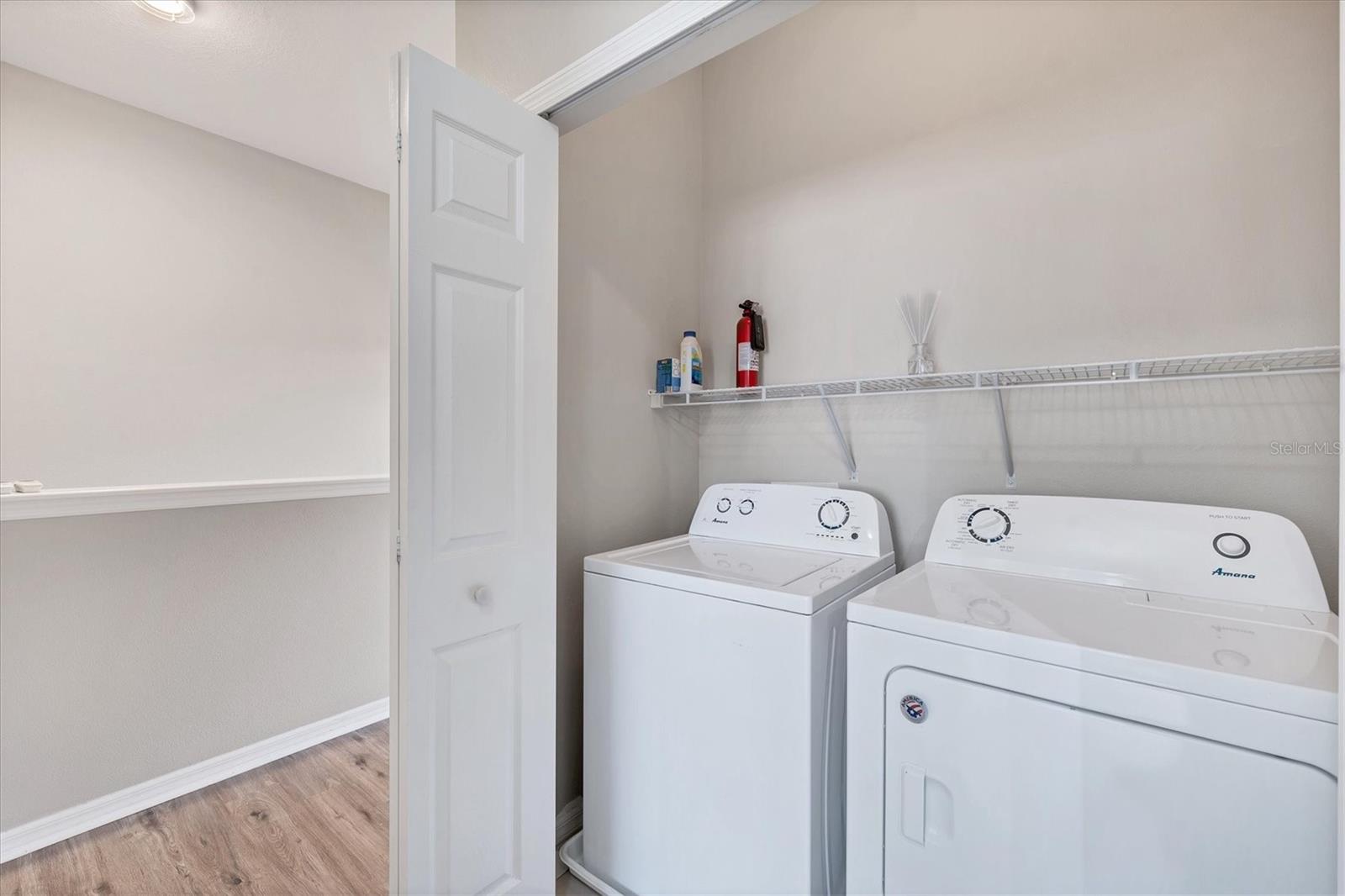 Full size washer and dryer in closet on 2nd floor- notice there is lots of space for additional shelves