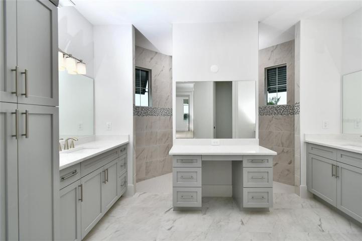 Roman walk-in shower, stone top double vanities, plus single seating area.