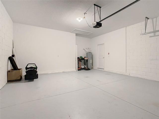 garage with an upgrade opener (lawn equipment excluded)