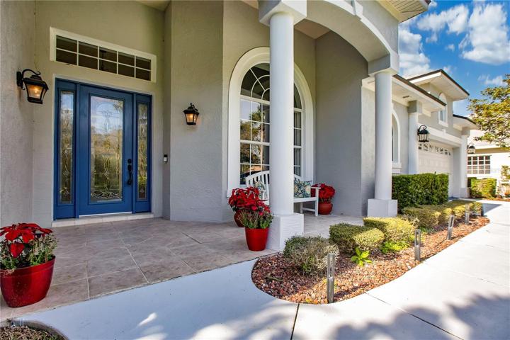 Beautifully paved and covered front porch greeting area