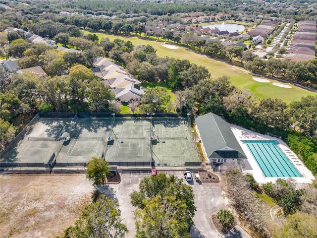 Aerial view showing tennis, clubhouse, and pool