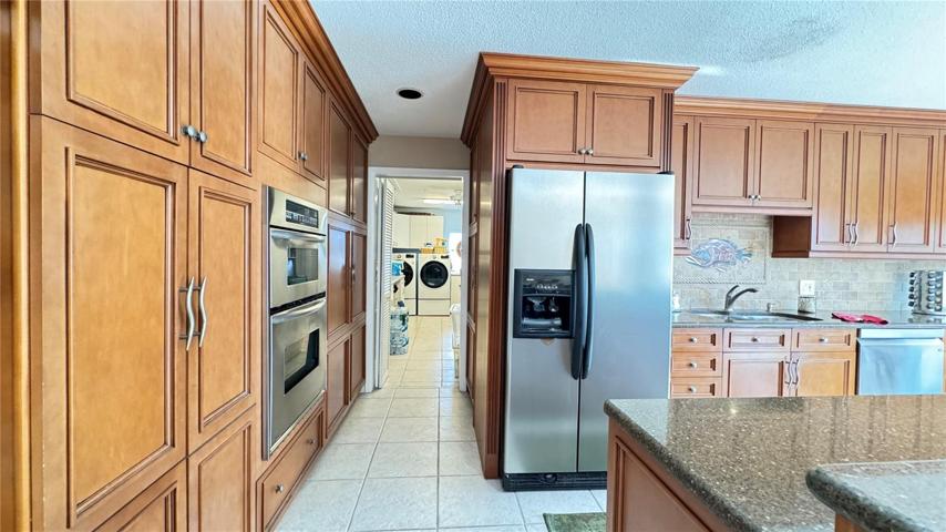 View of kitchen and laundry room beyond.