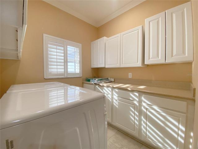 Laundry Room with Folding Counter Top Space and Cabinets