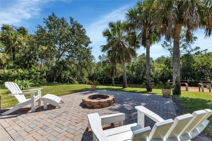 Firepit behind house in front of canal