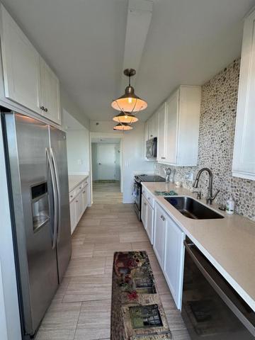 Kitchen Looking from Side Door to Balcony.