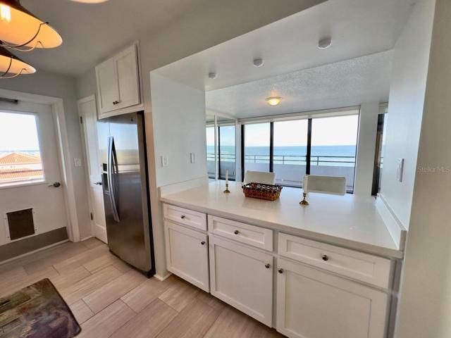 Kitchen with Ocean views and Plenty of Counterspace and Pull out shelving in these lower cabinets. Eating area on other side for Bar Stools or Chairs.