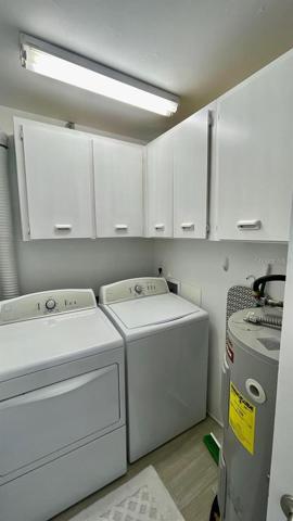 Laundry Room with Cabinets & Hot Water Heater.