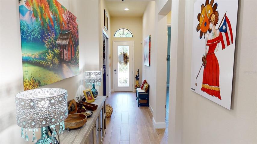 Foyer hall provides access to a private guest suite and front flex room