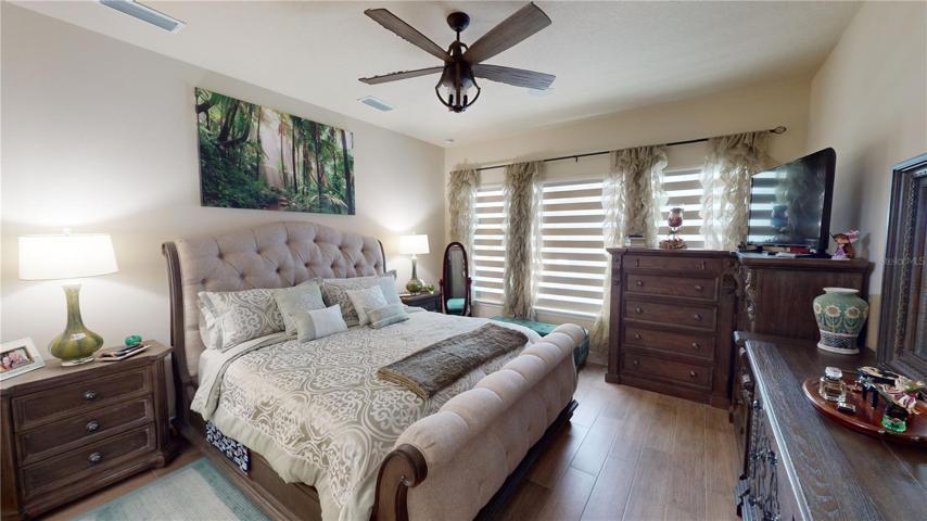 The primary bedroom is a sanctuary of relaxation, offering respite from the world and a space to rejuvenate. With a full bath at your disposal, convenience and comfort are paramount. The walk-in closet adds a touch of practical opulence, providing ample storage for your personal haven. As you gaze out from your window, the breathtaking views of the golf course unfold, offering a panorama of serene greens that blend seamlessly with the beauty of your living space.