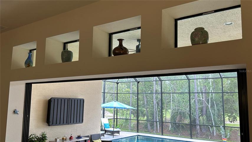 Elevate your space with elegance – above the grandeur of the 8-foot tall sliding glass door, exquisite decorative transom windows beckon. This thoughtful touch adds a touch of sophistication, allowing natural light to cascade into the room while creating a visual delight.