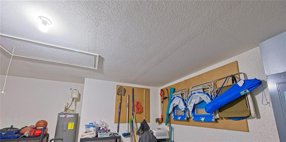 Garage storage areas and pull down stairs to attic.