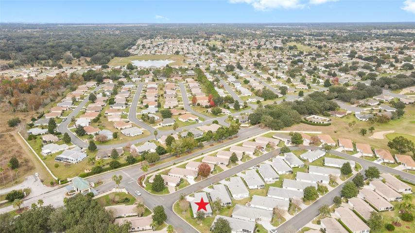 AERIAL VIEW: Del Webb Entrance bottom left, Del Webb Boulevard (tree lined road) running bottom left to middle right