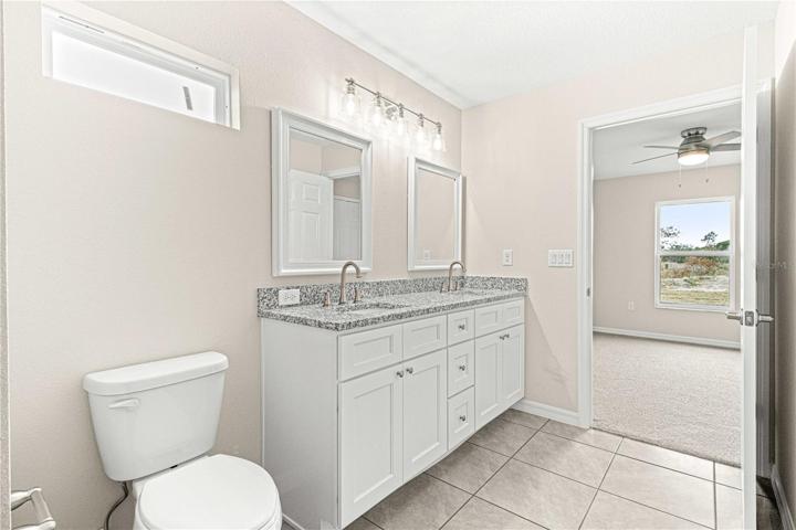 Jack and Jill bathroom with dual granite counter tops