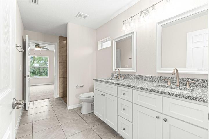 Jack and Jill bathroom with dual granite counter tops