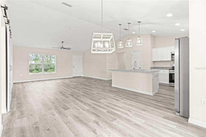 Dining area with chandelier and French doors leading out to the lanai