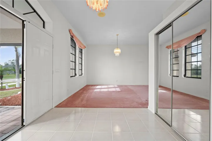 Large Breezeway with mirrored coat closet