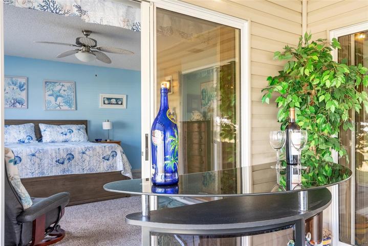 DRY BAR is situated in front of SLIDING GLASS DOORS to PRIMARY BEDROOM