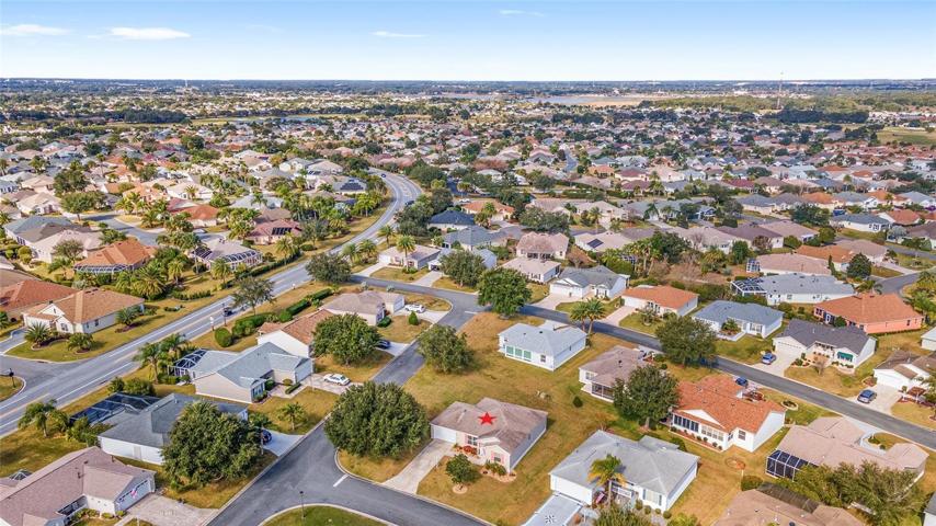 Looking NORTHWEST: Odell Circle (L), Lake Sumter Landing town square is visible on south side of Lake Sumter (body of water in upper R center on horizon).