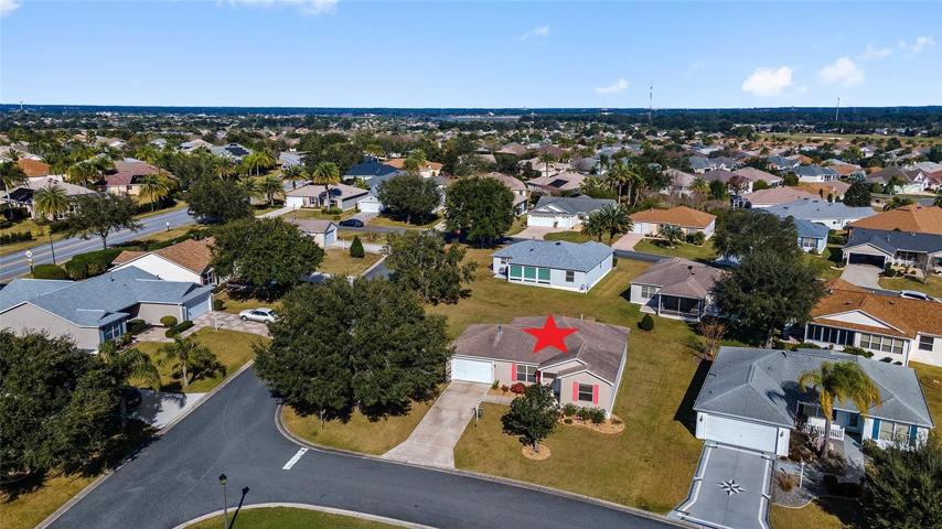 AERIAL FRONT EXTERIOR shows large corner lot with extra buffer space between homes.