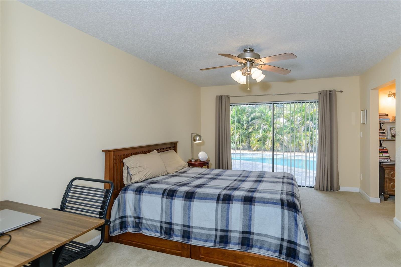 Your ensuite primary bedroom offers a view of the pool.