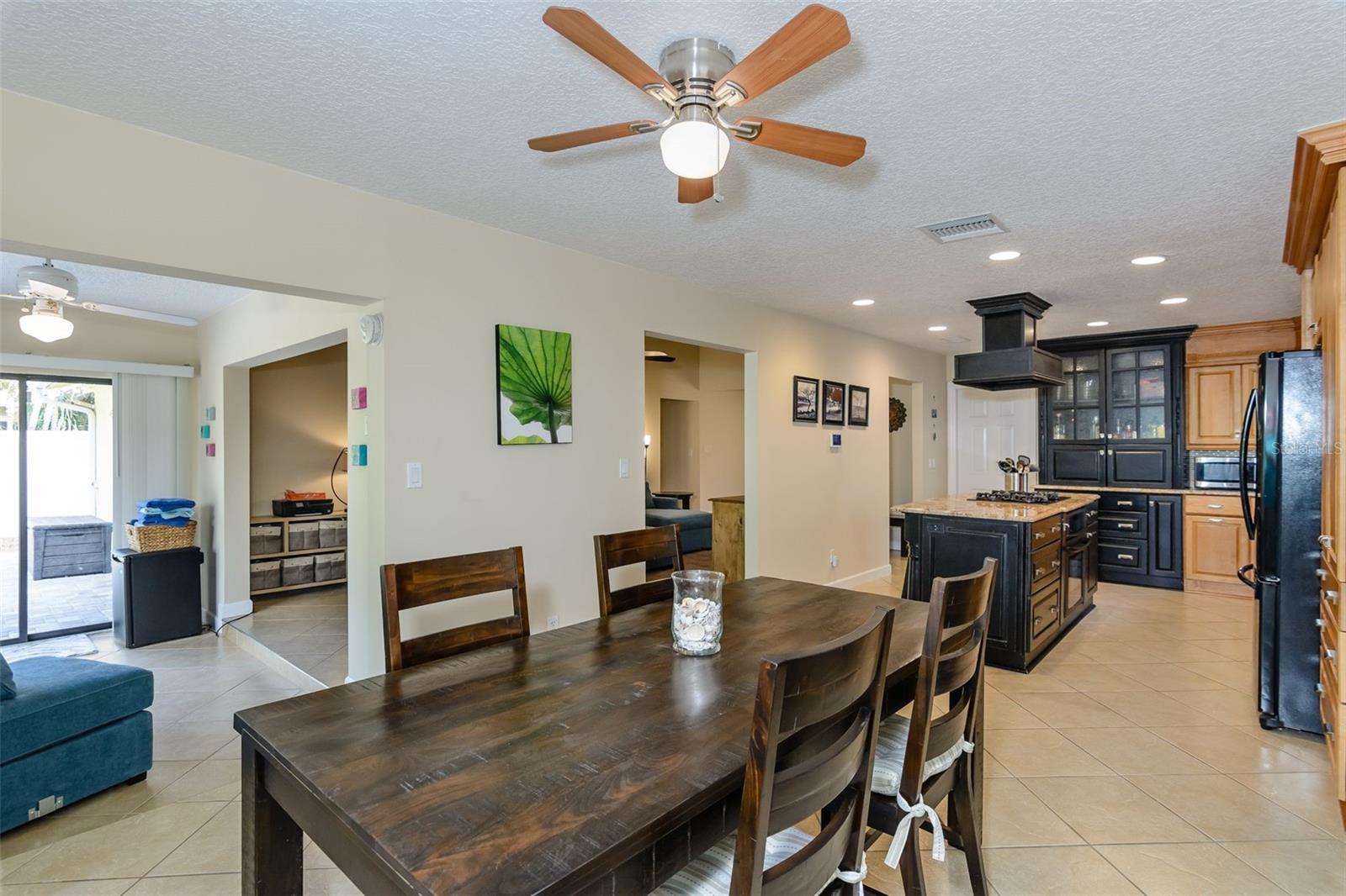 The view from the dining room shows the Florida room to the left, kitchen to the right and living room in the center.