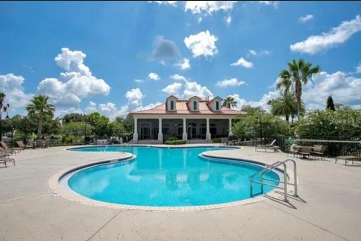 1/2 resort style swimming pool looking back at clubhouse