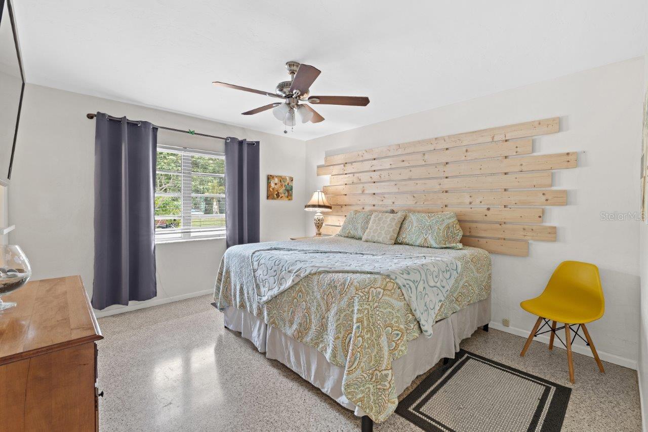 Owner suite featuring a custom accent wall, walk-in closet, and ensuite bathroom.
