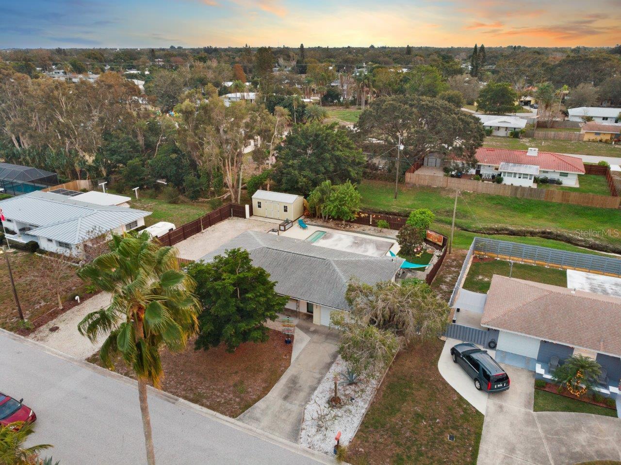 Aerial of the front elevation showing the extended driveway, and property size.