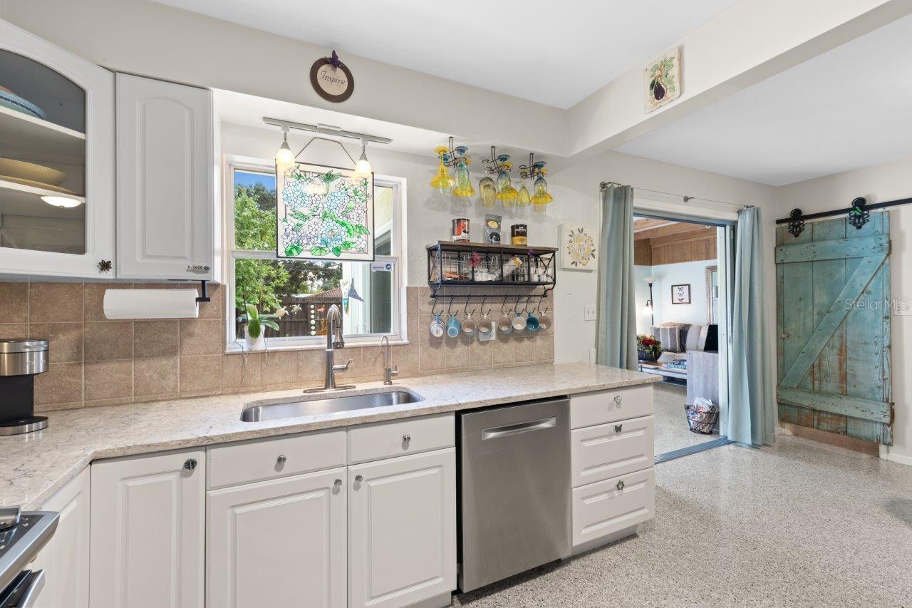 2020 Remodeled Kitchen featuring granite counters, new whirlpool stainless steel appliances, and ample cabinetry.