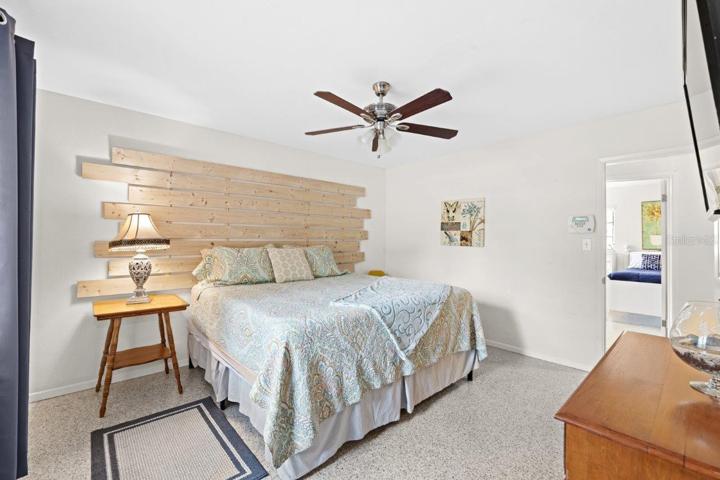 Owner suite featuring a custom accent wall, walk-in closet, and ensuite bathroom.