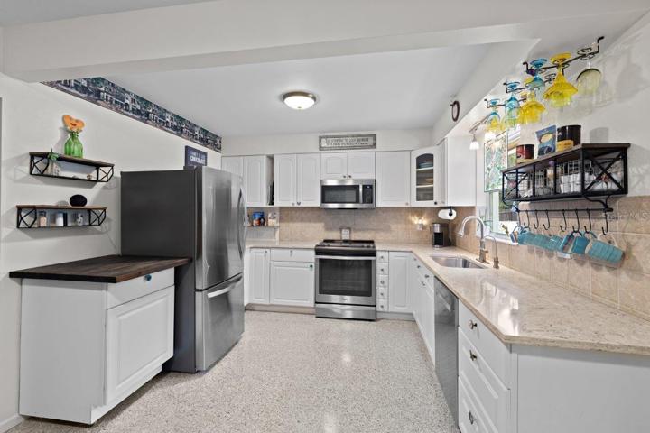 2020 Remodeled Kitchen featuring granite counters, new whirlpool stainless steel appliances, and ample cabinetry.