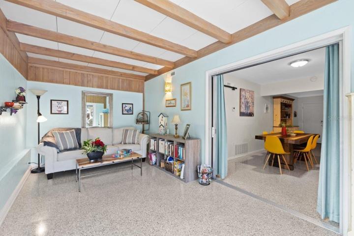 Family room located off the kitchen featuring decorative beams, and 180 degree views of the back yard oasis.