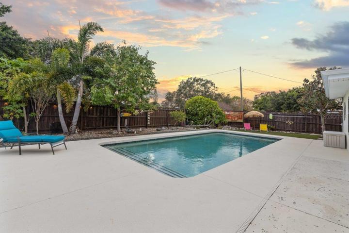 Back yard featuring a heated pool, extended lanai, fenced-in yard, 10'x20' shed, and artificial turf.
