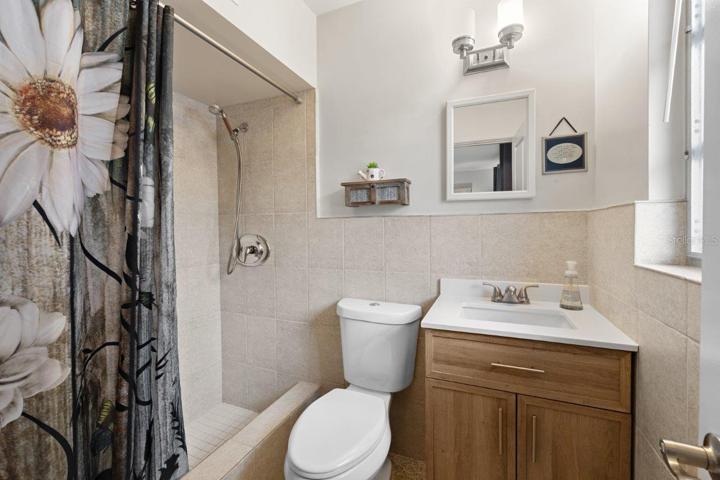 Owners ensuite bathroom featuring a walk-in shower, and update vanity.
